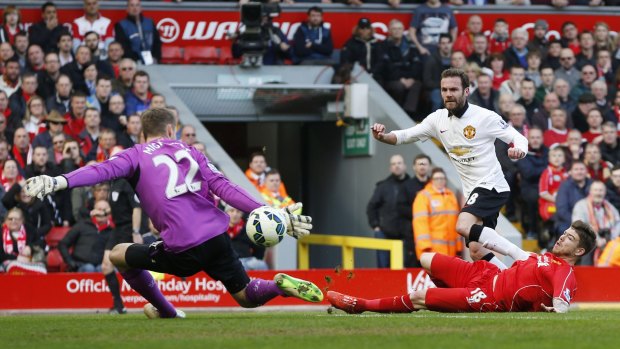 Juan Mata scores the first of two goals for Manchester United against Liverpool on Sunday.
