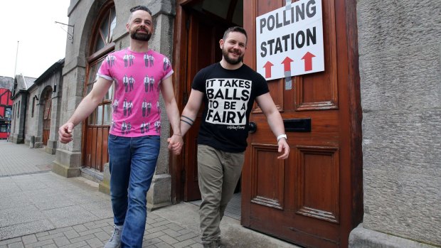 A gay couple walks out of a polling station after voting in Drogheda, north Dublin on Friday.