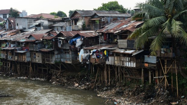 Shanty houses along a river in Jakarta last month.