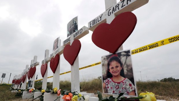 Crosses showing shooting victims names stand near the First Baptist Church in Sutherland Springs, Texas. 