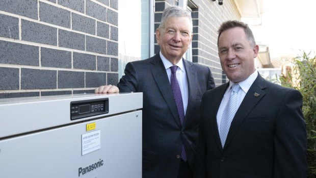 ActewAGL CEO Michael Costello and Panasonic Australia's managing director Paul Reid with a battery storage system at a home in Forde.