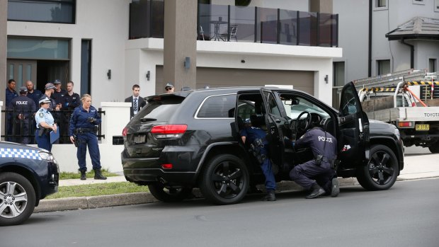 Police search the home of the Alameddine family, some of whom are subject to firearms prohibition orders, in December 2015.