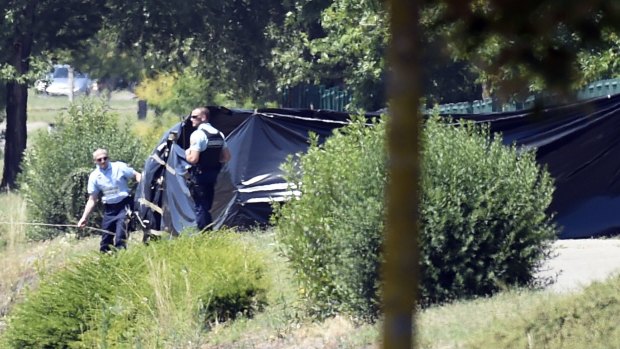 French security at the enclosed area where a decapitated body was found.