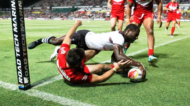 Merciless: Suliasi Vunivalu scores one of Fiji's many tries.