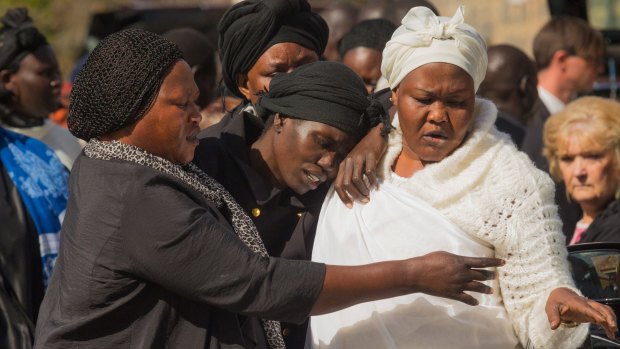 Akon Guode (centre), pictured as she left a funeral service for her children in April, 2015.