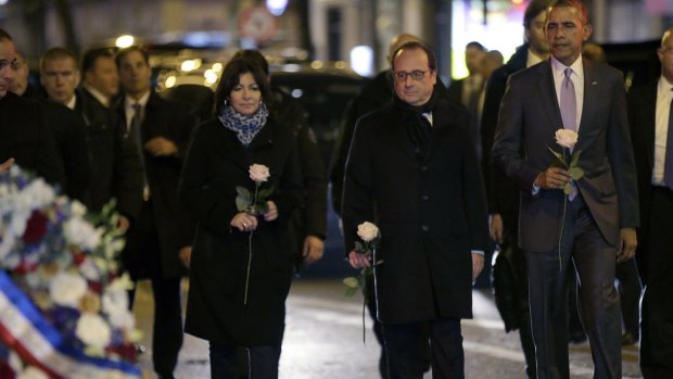 US President Barack Obama, right, French President Francois Hollande and Paris Mayor Anne Hidalgo pay their respects at the Bataclan concert hall, one of the sites of the November 13 attacks.