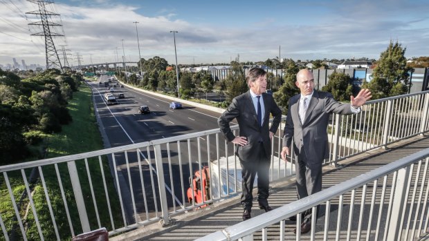 Roads Minister Luke Donnellan (left) on Monday with Western Distributor Authority chief executive Peter Sammut. They in Yarraville above the West Gate Freeway. 