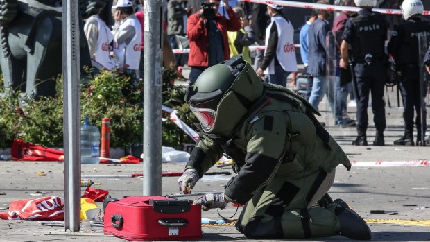 A Turkish bomb disposal expert investigates a suitcase at the scene of a blast during a peace rally in Ankara in October.