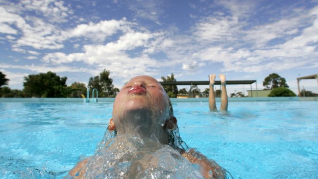 Children splash around at the Inglewood public swimming pool.  