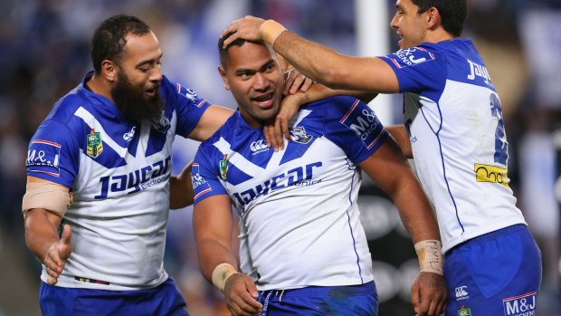 Tony Williams celebrates with teammates after scoring a try during the round 16 match against Brisbane at ANZ Stadium.