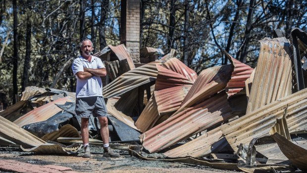 A home belonging to Richard Graham that lost in the Tarago fires. Farm-hand Scott Williams checks the damage.