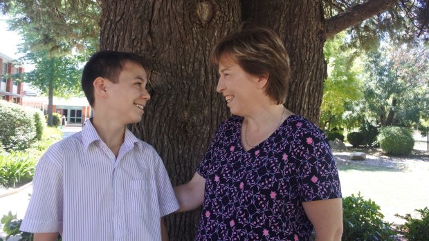 Daramalan College student Dylan Joe, 13, with his mum Jill Pareezer. Dylan, who cares for his mum who has disabilities, has been chosen to turn on the lights at Enlighten.