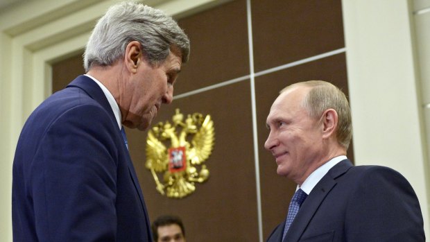 US Secretary of State John Kerry, left, shakes hands with Russian President Vladimir Putin in Sochi, Russia in May.