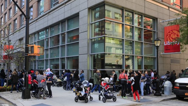 A queue for story time stretches around the block outside the Battery Park City Branch Library in New York.