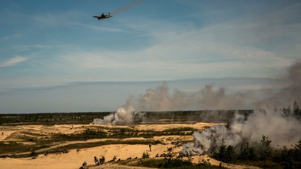 A US Air Force A-10 Thunderbolt fighter jet fires rounds into a target range over Latvian forces during Saber Strike 2015. 