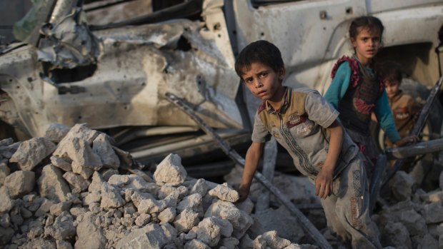 'The humanitarian crisis continues': Iraqi children amid the rubble of Mosul.