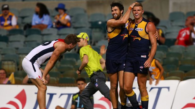 Warm welcome: Josh Kennedy celebrates a goal with ex-Cat Nathan Vardy.