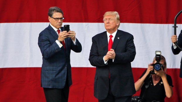 Climate deniers: President Donald Trump and Energy Secretary Rick Perry, left, at a scout event in July.