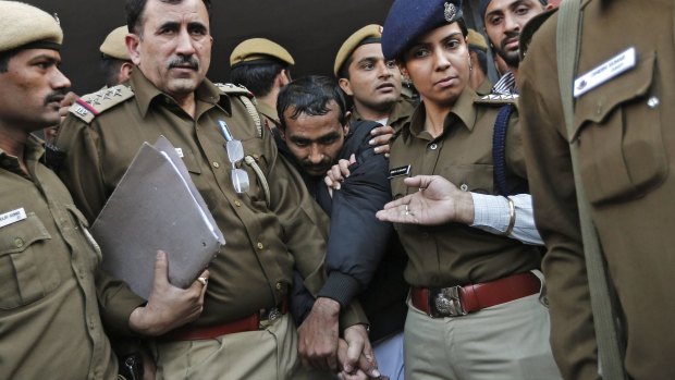 Not excluded by Uber: Police officers escort driver Shiv Kumar Yadav outside a court in Delhi.