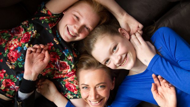 Renae Smith with her daughters, Kyah, 13, (in blue) and Paris, 11, in their Newtown home in Sydney.