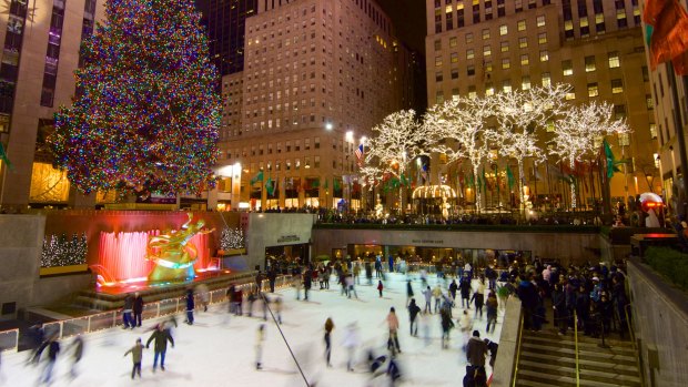 Tourists and skaters get in the Christmas spirit at New York's Rockefeller Centre. 