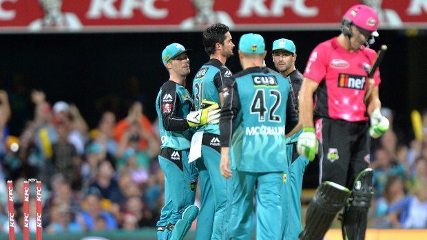 Late drama: The Heat celebrate Hughes' dismissal in the final over, but it wasn't enough.