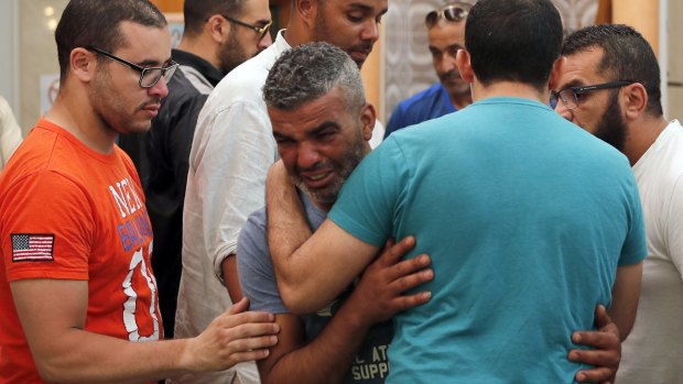 Tahar Mejri is comforted by friends after carrying the coffin of his 4-year-old son, Kylan, at the ar-Rahma mosque in Nice. Tahar's wife, Olfa Kalfallah, was also killed.
