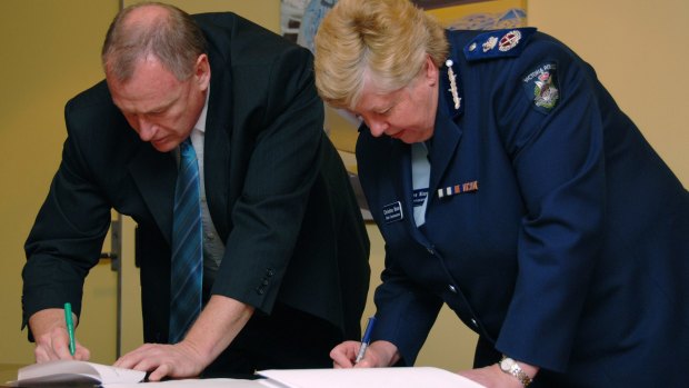 In happier times: Police Association boss Paul Mullett and chief commissioner Christine Nixon sign a police pay deal in 2007.