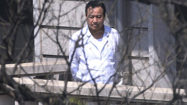 South Korean Prime Minister Lee Wan Koo walks on the terrace of his residence in Seoul after offering to resign just two months after he took up the country's No 2 post.