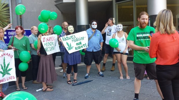 Supporters for a man who allegedly gave his sick daughter cannabis oil stand outside Brisbane Magistrates Court. 