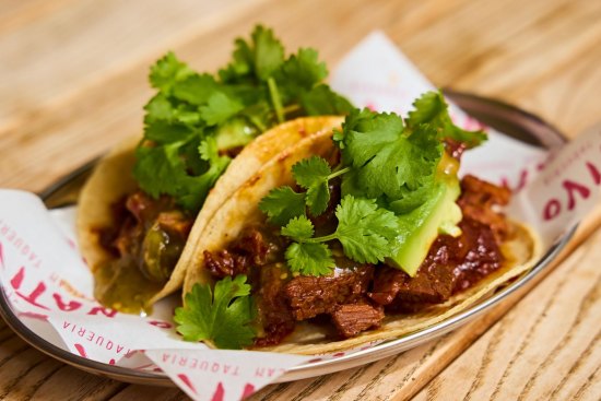 Beef birria tacos with Oaxaca cheese and salsa verde.