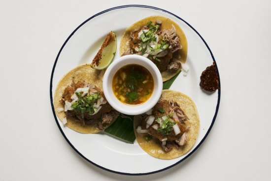 The lamb barbacoa features a slow-cooked lamb shoulder that hangs like fine ribbons on a tortilla.