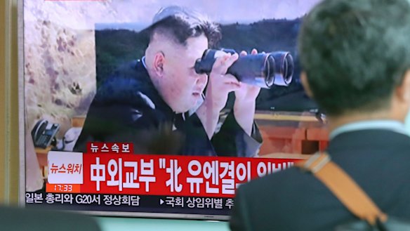 A man at Seoul train station in South Korea watches local TV coverage of the missile test.