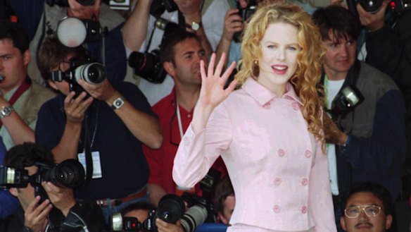 Nicole Kidman, waves to photographers before her press conference for the film " To Die For".