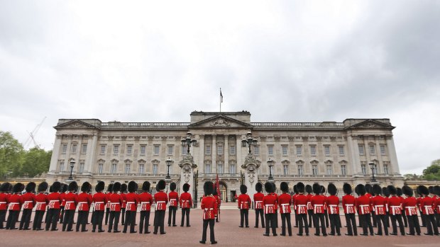 Breached: Guardsmen parade outside Buckingham Palace.