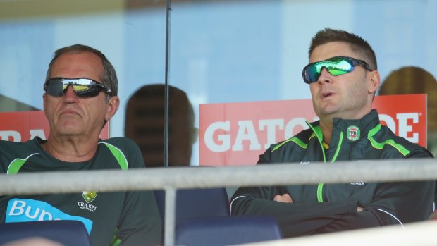 Time out: Michael Clarke, right, watches the one-day game between Australia and South Africa on Friday with team doctor Peter Brukner.