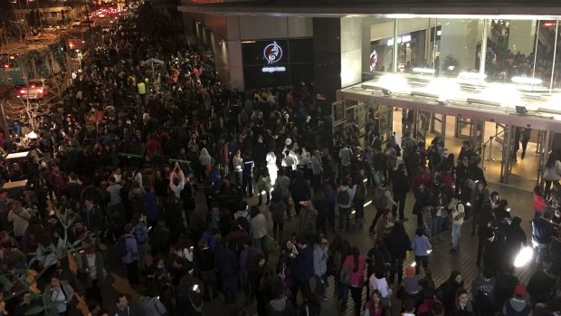 People evacuate a shopping mall in Santiago after a powerful earthquake hit off Chile's northern coast.