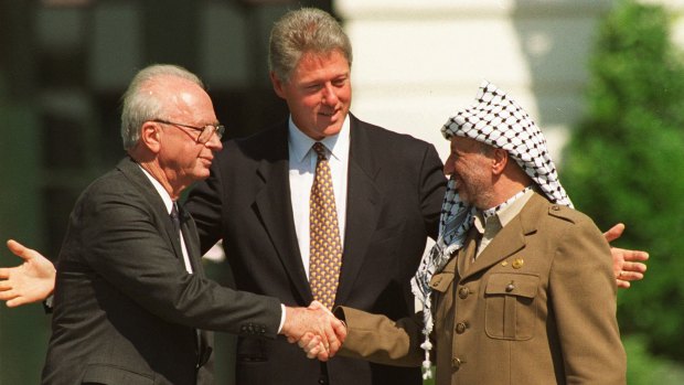 US president Bill Clinton with Rabin and Palestine Liberation Organisation chairman Yasser Arafat mark the signing of the first Oslo peace accord with a handshake at the White House in September 1993.