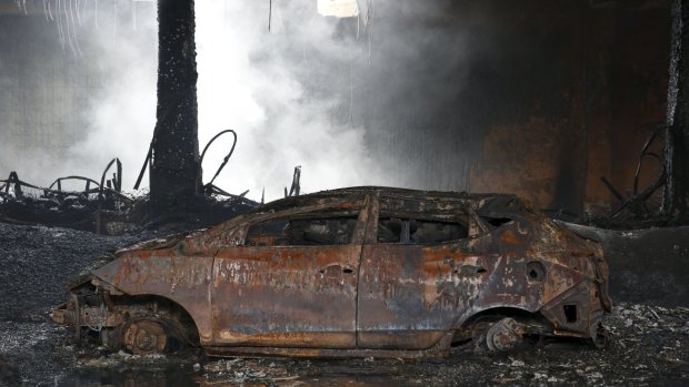 A burnt car is seen inside the gutted footwear factory in Valenzuela