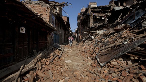 A Nepalese man walks through destruction caused by Saturday's earthquake in Bhaktapur.