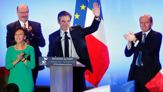 French conservative presidential candidate Francois Fillon waves to supporters as he arrives to deliver a speech during a campaign meeting in Maisons-Alfort, outside Paris.