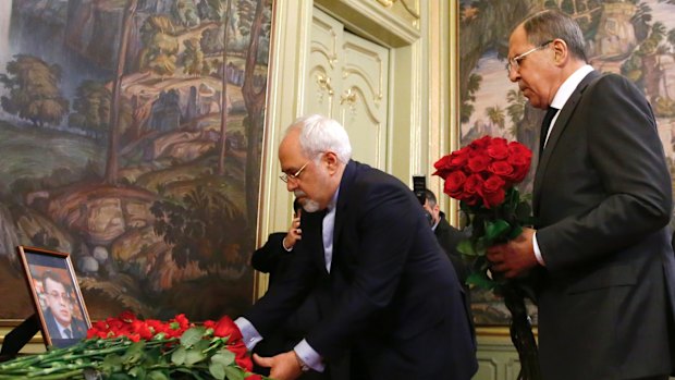 Mohammad Javad Zarif and Sergei Lavrov lay flowers in tribute to Russia's ambassador to Turkey, Andrei Karlov, who was assassinated in Ankara on Monday.