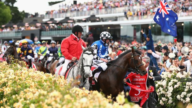 Araldo (in background) is frightened by an Australian flag, as jockey Dwayne Dunn rides him back to the mounting yard.