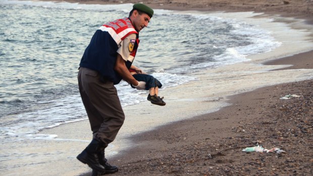 A police officer carries three-year-old Aylan Kurdi after he drowned near the Turkish resort of Bodrum.