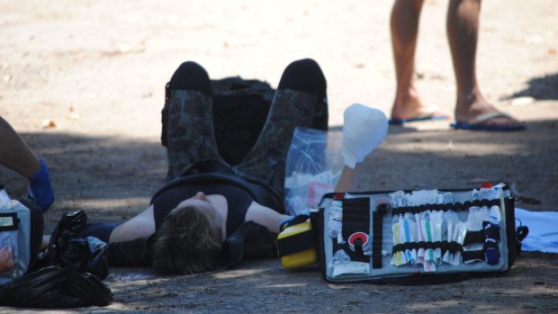 The teenager is treated by paramedics.