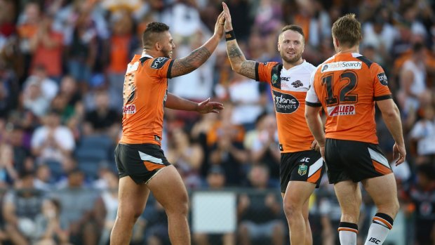 Tigers burning bright: Josh Aloiai, Jordan Rankin and Chris Lawrence celebrate Tigers' round-one victory against the New Zealand Warriors at Campbelltown Sports Stadium.
