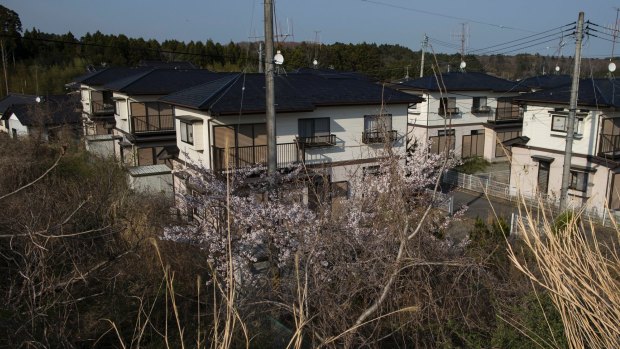 Uninhabited houses in Naraha, Japan,  six years after an earthquake and tsunami caused a meltdown at a nuclear power plant north of town.
