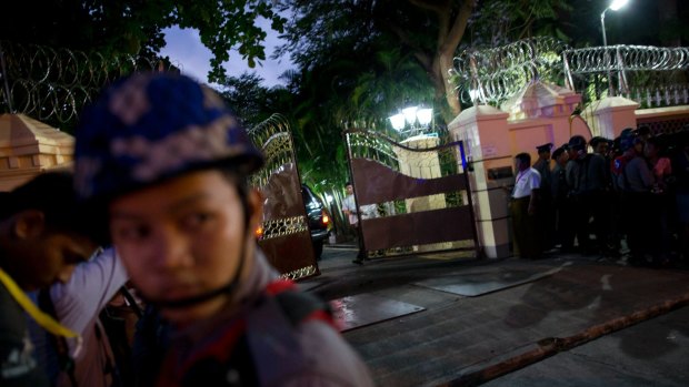 A security officer closes the gate of Bishop house after a convoy of vehicles carrying Myanmar's military leader, General Min Aung Hlaing, enters to meet Pope Francis.
