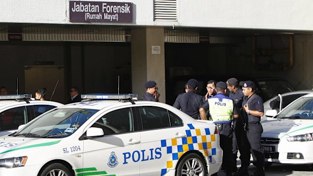 Police officers at the entrance to the hospital in Putrajaya, Malaysia, where Kim Jong-nam's body was taken.