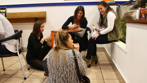 Women enjoy a meal in the floor of a pie restaurant in Newtown.